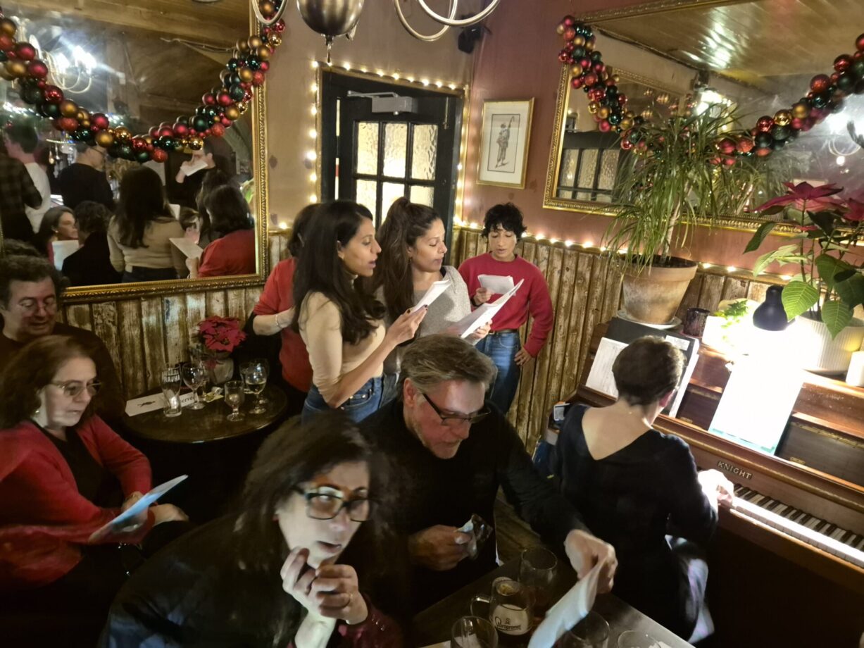 Singing Christmas carols at The Harlequin pub, Clerkenwell, London