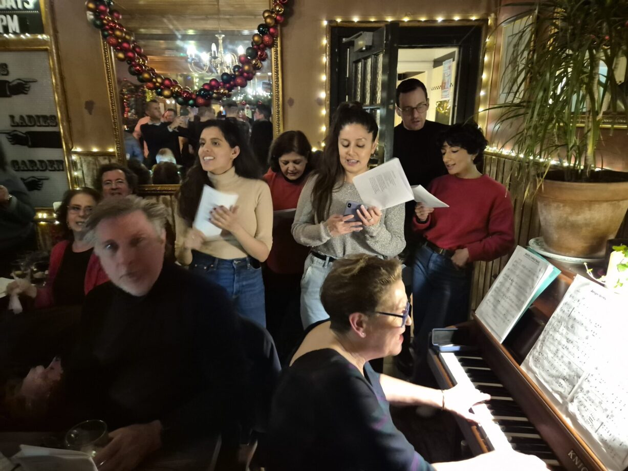 Singing Christmas carols at The Harlequin pub, Clerkenwell, London