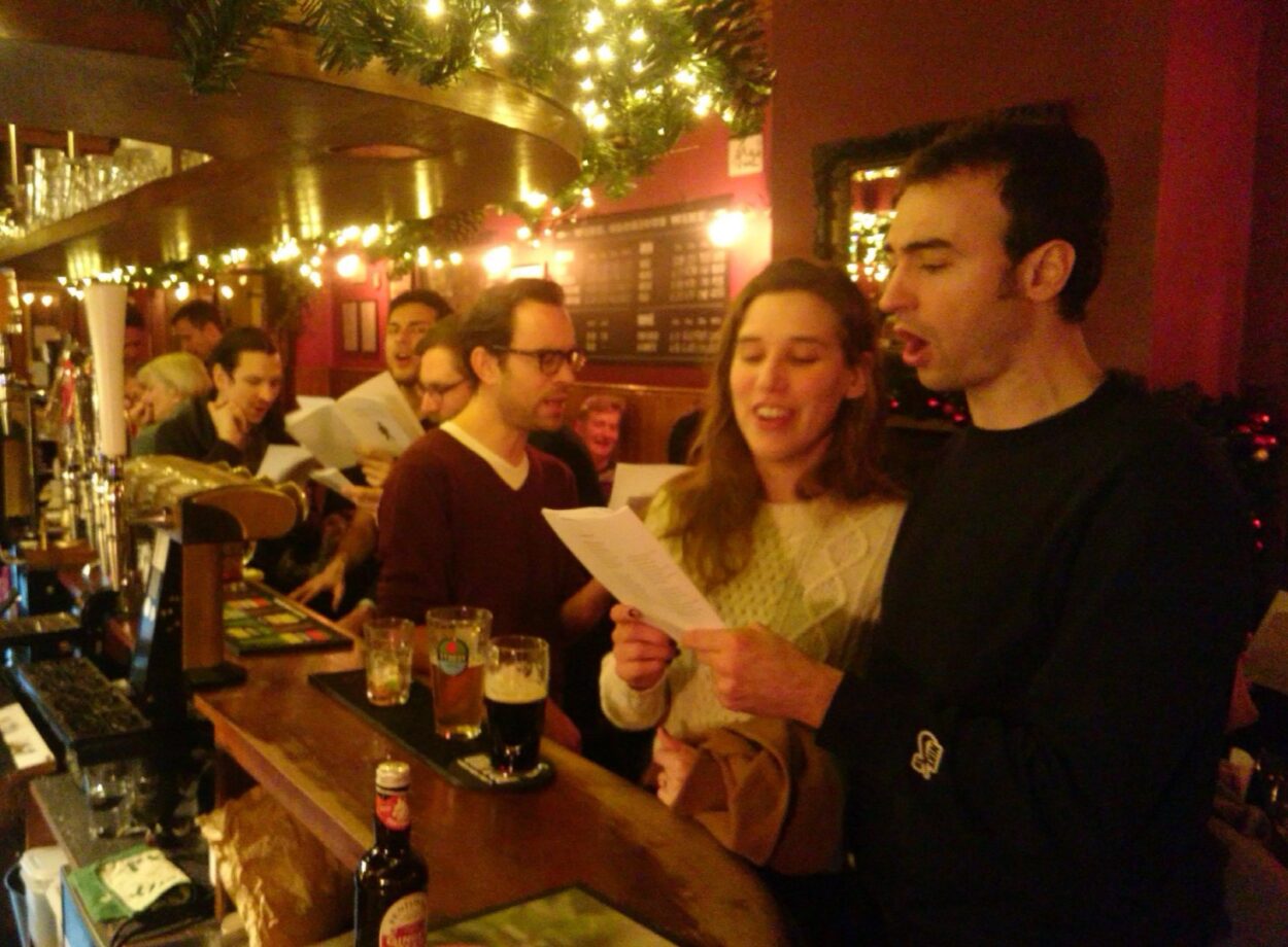 Singing Christmas carols at The Harlequin pub, Clerkenwell, London